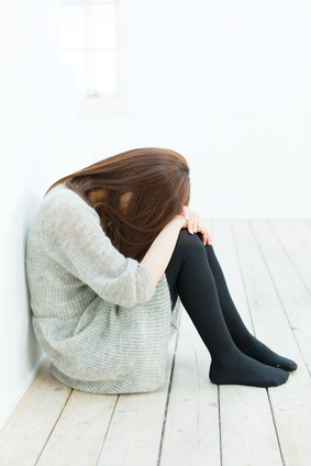 Beautiful sad woman sittiing in the room